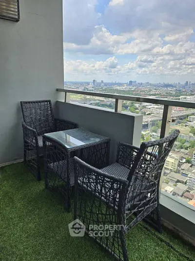 Stunning balcony view with stylish outdoor seating and lush artificial grass.