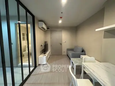Modern living room with glass partition and sleek furniture