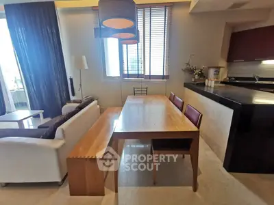 Modern open-layout living and dining area with stylish furniture and natural light.