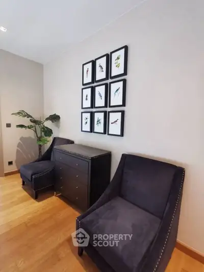 Stylish interior with elegant chairs and framed bird art on wall, perfect for modern living.
