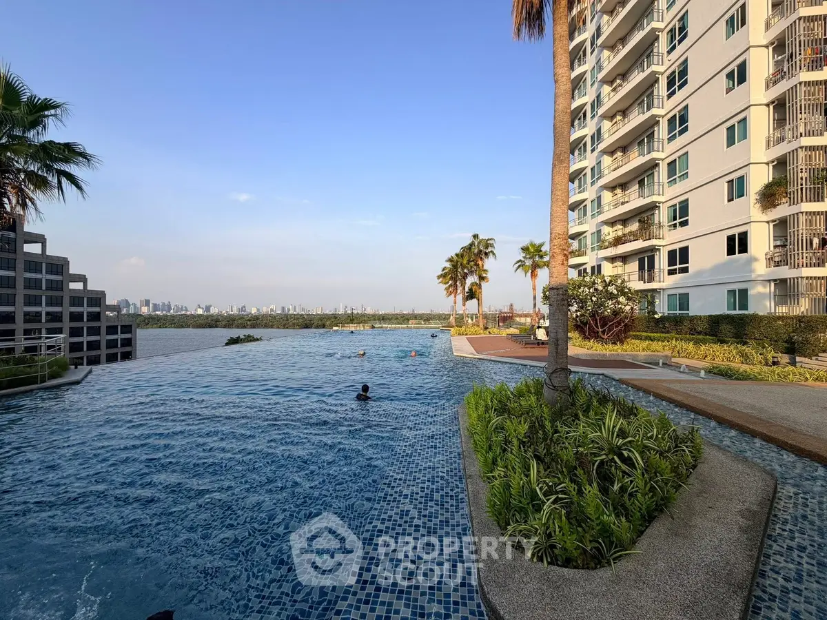 Luxurious high-rise apartment with stunning infinity pool and city skyline view.
