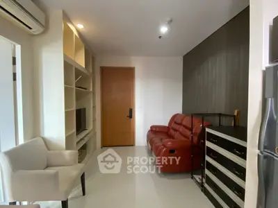 Cozy living room with red leather sofa and modern shelving
