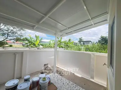 Spacious balcony with a view of lush greenery, perfect for relaxation and outdoor activities.