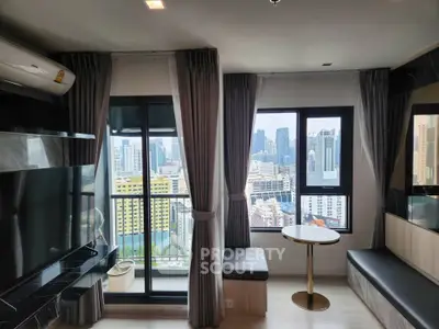Modern living room with city view, featuring large windows and stylish decor.