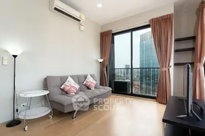 Modern living room with city view, featuring a cozy sofa and large window for natural light.