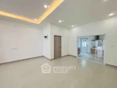 Spacious modern living room with open layout and sleek kitchen view