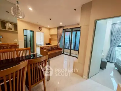 Spacious modern living room with dining area and balcony access in a stylish apartment.