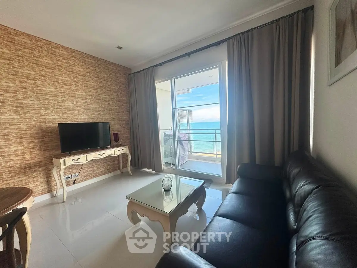 Chic living room with ocean view, elegant furniture, and large windows for natural light.