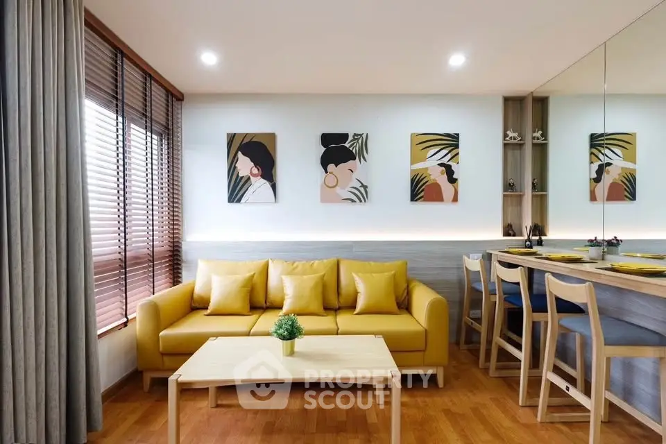 Stylish living room with yellow sofa, modern decor, and wooden flooring, perfect for cozy gatherings.