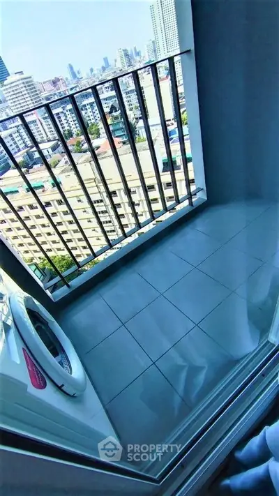 High-rise apartment balcony with city view and washing machine