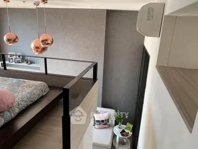 Modern loft bedroom with stylish decor and cozy seating area