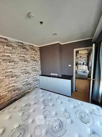Modern bedroom with stylish wallpaper and cozy furnishings in a contemporary apartment.