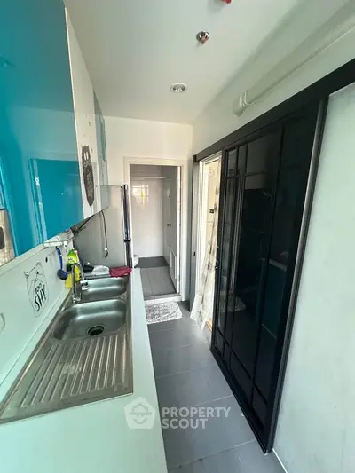 Compact kitchen with sleek design and modern appliances in a cozy apartment.