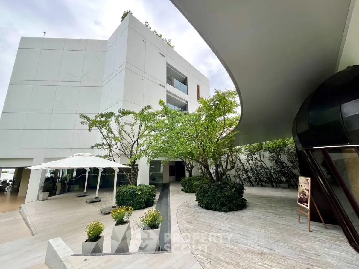Modern building exterior with lush greenery and sleek architectural design