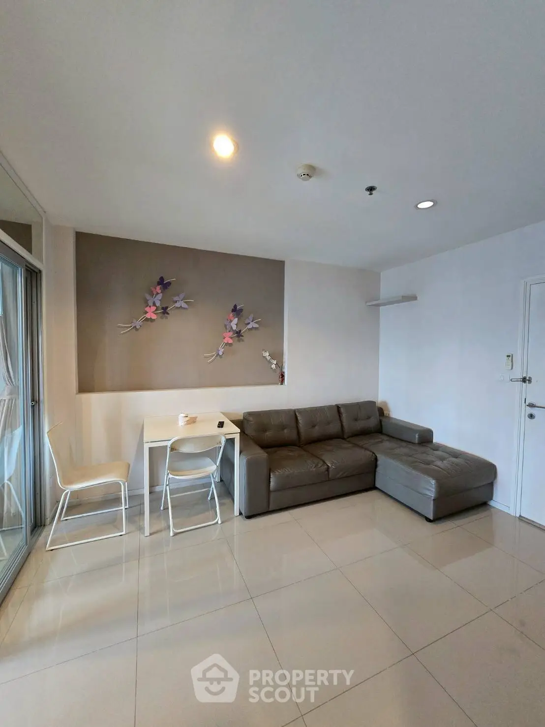 Modern living room with sleek sofa and dining area in open layout