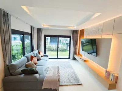 Spacious modern living room with large windows and stylish decor