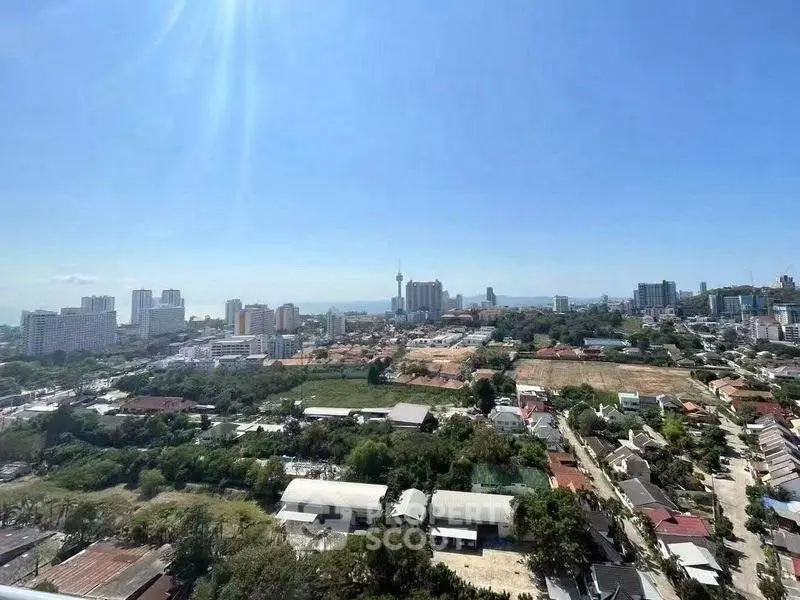 Stunning cityscape view from high-rise building showcasing urban skyline and lush greenery.
