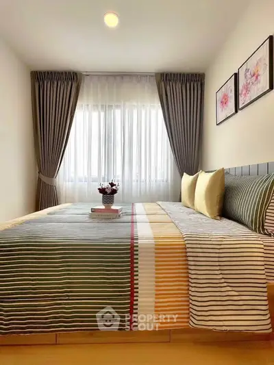 Cozy bedroom with stylish decor and natural light, perfect for relaxation and comfort.