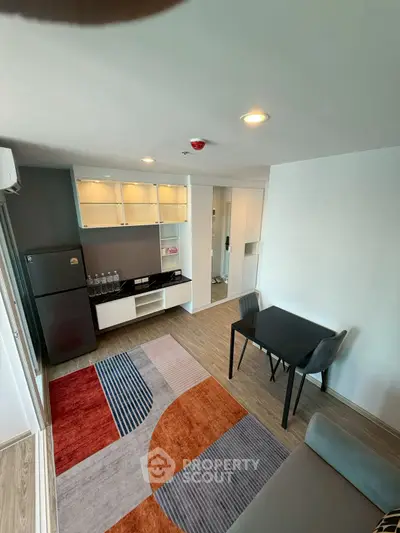 Modern living room with stylish decor and compact dining area