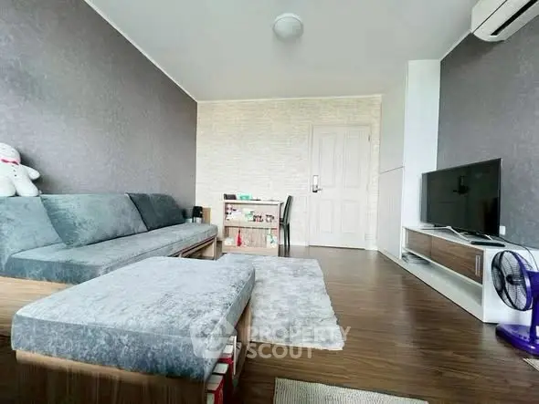 Modern living room with stylish furniture and TV setup, perfect for relaxation.