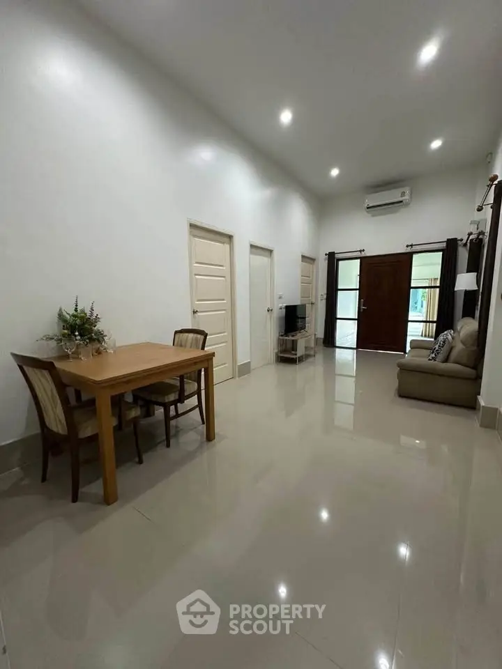 Spacious living room with modern furniture and sleek tile flooring
