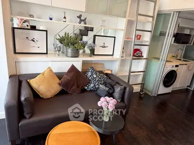 Stylish living room with modern decor and built-in shelving, featuring a cozy sofa and contemporary artwork.