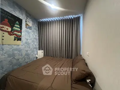 Cozy bedroom with brown bedding and festive wall decor, perfect for a restful retreat.