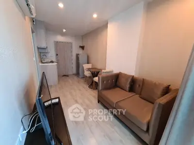 Modern living room with open kitchen layout and stylish furniture