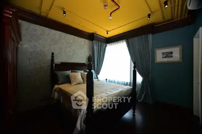 Luxurious bedroom with elegant decor and large window for natural light.