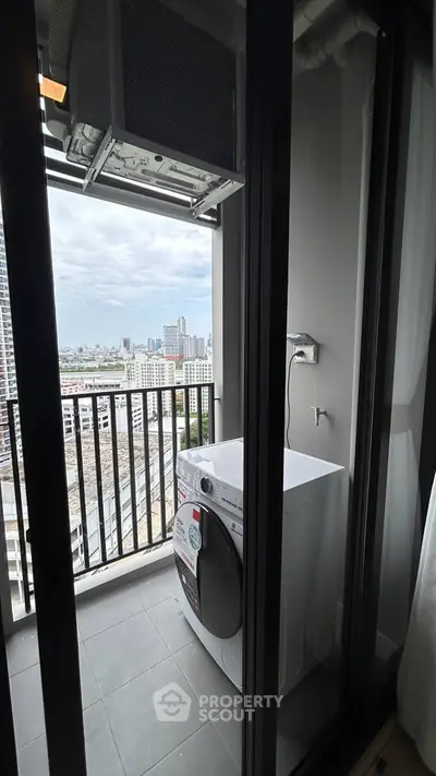 Modern high-rise balcony with washing machine and city view, perfect for urban living.