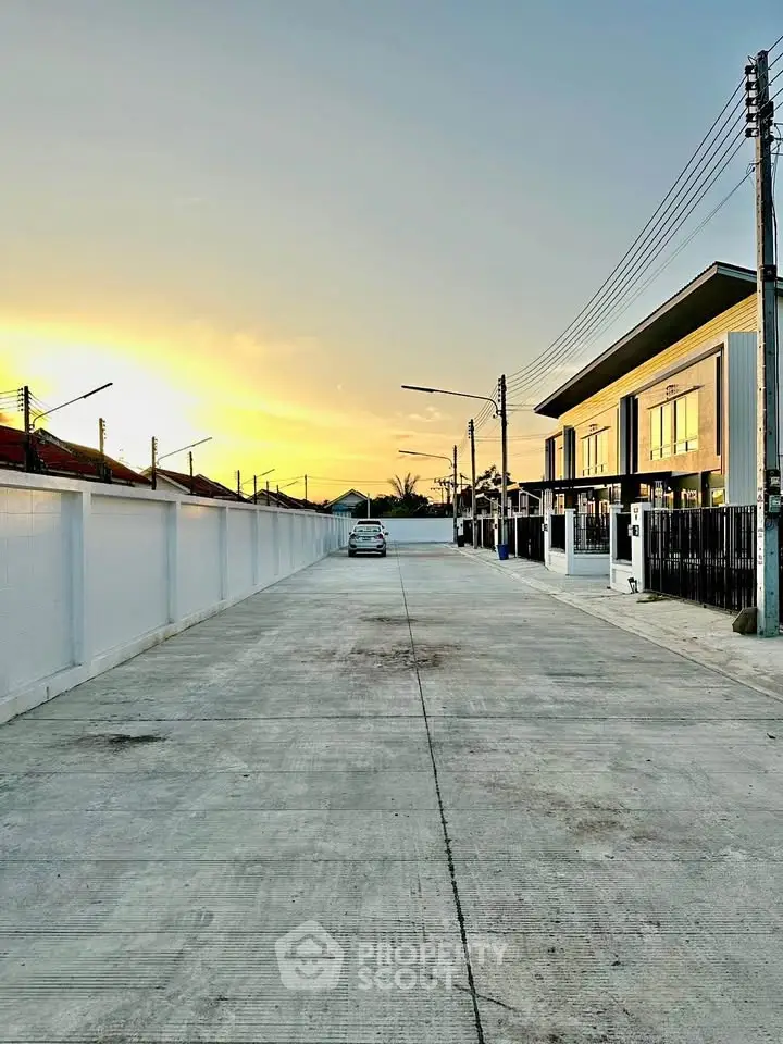 Modern residential street with sunset view and contemporary houses