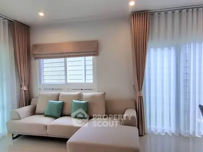 Elegant living room with cozy beige sofa and stylish curtains