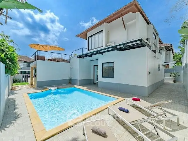 Stunning modern villa with private pool and spacious outdoor area under clear blue skies.