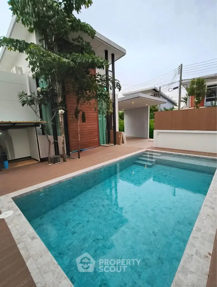 Luxurious modern home with private pool and elegant exterior design.