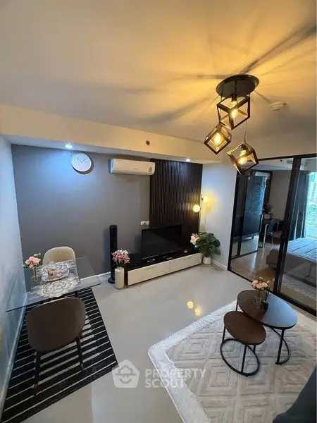 Modern living room with stylish lighting and glass dining table