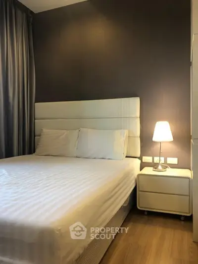 Cozy bedroom with modern decor and soft lighting, perfect for relaxation.