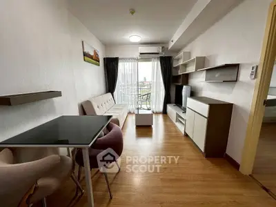 Modern living room with stylish furniture and balcony view in a contemporary apartment.