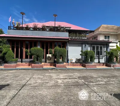 Charming residential building with lush greenery and unique architectural design.