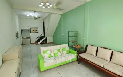 Spacious living room with modern furniture and green accent wall