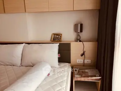 Cozy bedroom with modern decor and soft lighting, featuring a comfortable bed and stylish nightstand.