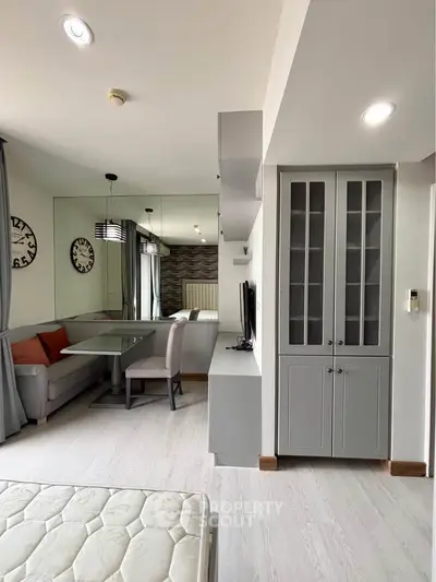 Modern living room with stylish dining area and built-in storage