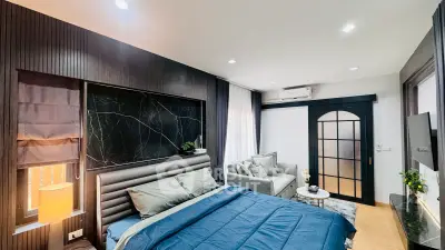 Luxurious modern bedroom with elegant decor and cozy seating area
