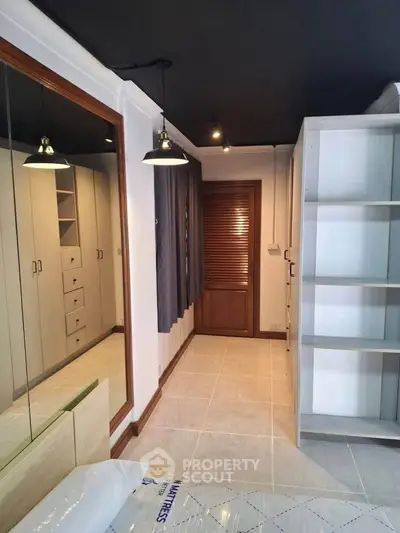 Spacious modern bedroom with built-in wardrobe and stylish lighting