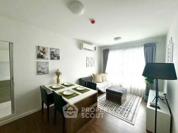 Modern living room with dining area, stylish decor, and natural light.