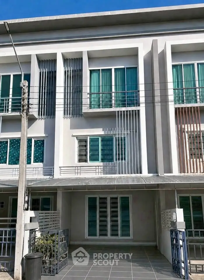 Modern townhouse exterior with sleek design and large windows, perfect for urban living.