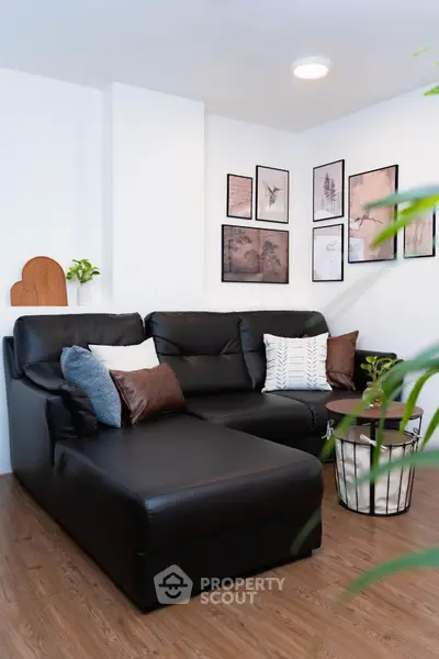 Stylish living room with black leather sectional sofa and modern decor