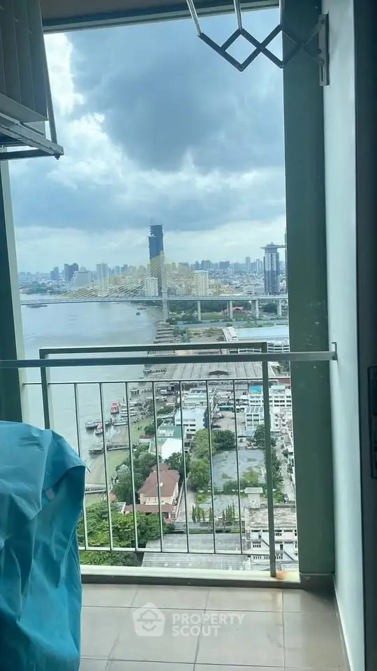 Stunning high-rise balcony view overlooking river and city skyline, perfect for urban living.