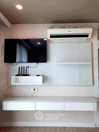 Modern living room with wall-mounted TV and air conditioning unit