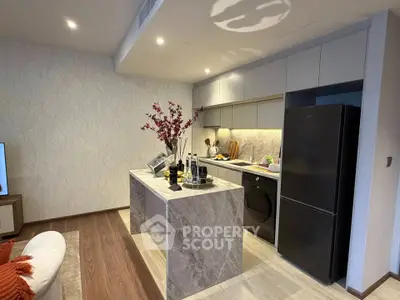 Modern kitchen with sleek appliances and stylish island in contemporary apartment.