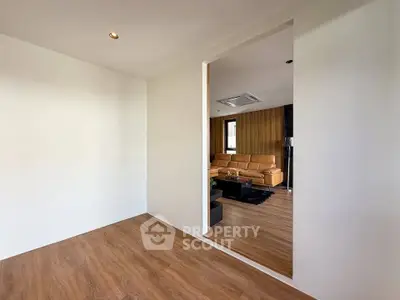 Modern living room with wooden flooring and stylish furniture